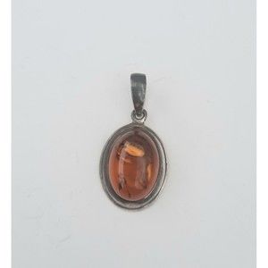 Vintage sterling silver Baltic amber pendant. 1 1/2 inch long and 3/4 inch wide.
